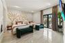 Large bedroom featuring polished tile flooring, a custom decorative wall mural, recessed lighting, and sliding glass doors with direct exterior balcon