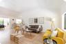 Open-concept interior featuring high vaulted ceilings, wood-finish flooring, and crown molding