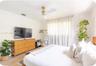 Neutral wall palette featuring wood-finish flooring and a ceiling fan with a metallic finish