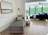 Wood-finish flooring throughout, sliding glass doors, and a ceiling fan