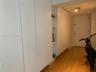 Custom floor-to-ceiling cabinetry featuring integrated shelving, flat-panel white doors, and wood-finish flooring