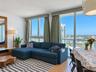Floor-to-ceiling windows, wood-finish flooring, built-in wooden media console, and recessed lighting