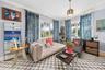 Multi-pane windows, crown molding, wall-mounted ductless climate control system, and a decorative ceiling-mounted light fixture