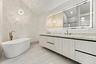 Gorgeous primary bathroom with free standing soaking tub and crystallo quartzite countertops