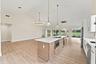 Custom chef's kitchen with brand new GE appliances and beautiful gold accents throughout