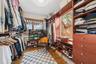 Custom built-in wood cabinetry, integrated drawer storage, open shelving, and wood-finish flooring