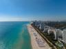 Coastal location featuring direct beach access, expansive shoreline, and proximity to high-rise metropolitan infrastructure