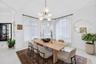 Dining area featuring three large arched windows, vaulted ceiling, and a modern multi-globe chandelier with a metal finish