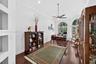 Room featuring wood-finish flooring, recessed lighting, crown molding, built-in wall niches, and arched windows