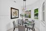 Nook featuring triple-pendant light fixture, large pane windows, and neutral tile flooring