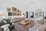 High ceilings featuring recessed lighting, expansive glass double doors with an arched transom, and light-toned hard-surface flooring