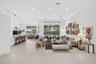 Open-concept living space featuring large-format tile flooring, recessed lighting, floor-to-ceiling glass windows, and a built-in kitchen island with 
