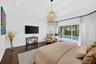 Tray ceiling, dark wood-finish flooring, and woven spherical pendant lighting