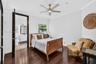 Dark wood-finish flooring, recessed lighting, crown molding, and a modern ceiling fan with integrated lighting
