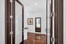 Double doors featuring dark wood frames with frosted glass panels, wood-finish flooring, and recessed ceiling lighting