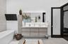 Floating wood-finish vanity with an integrated countertop, rectangular undermount sink, backlit rectangular mirror, and a freestanding soaking tub