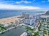 Aerial perspective featuring coastal shoreline, ocean access, waterway inlet, and multi-story residential structures
