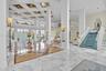 Grand foyer featuring a coffered ceiling, polished stone flooring with wood-finish inlays, structural columns, and an open staircase with a custom rai