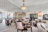 Floor-to-ceiling mirrored wall paneling, crystal tiered chandelier, and built-in glass-front cabinetry