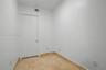 Neutral-toned interior room featuring light-colored wall finish and diagonal-set tile flooring