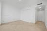 Neutral interior space featuring polished tile flooring, recessed lighting, and dual-panel closet doors
