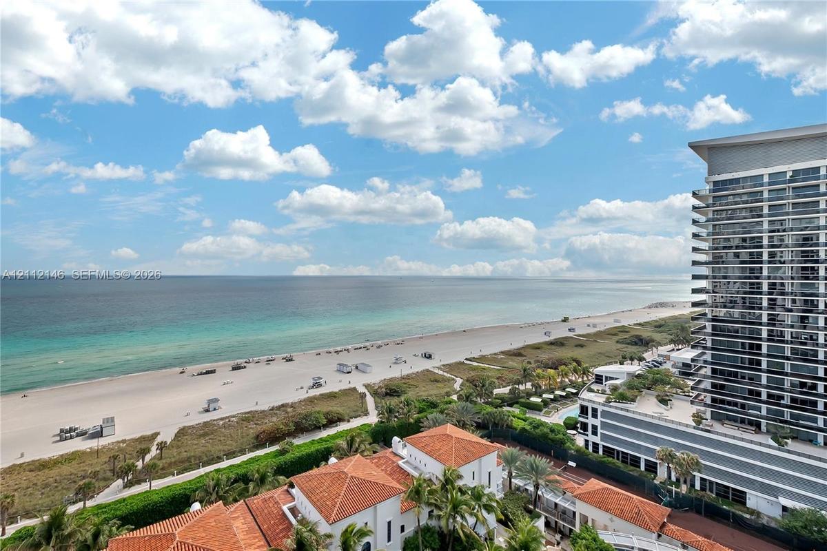 High-rise perspective featuring panoramic coastline and ocean scenery, clay tile roof architecture, and lush tropical landscaping