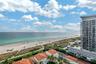 High-rise perspective featuring panoramic coastline and ocean scenery, clay tile roof architecture, and lush tropical landscaping