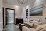 Stone tile flooring, wainscoting with integrated stone-finish panels, recessed shelving, and a spherical semi-flush mount light fixture
