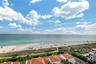 Elevated coastal perspective featuring expansive ocean horizons, a white sand beach, and terra-cotta roof architectural elements