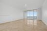 Polished stone flooring, floor-to-ceiling glass doors, and a private balcony