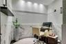 Polished stone wall tile, mosaic tile accent wall, recessed ceiling lighting, and built-in floating shelf