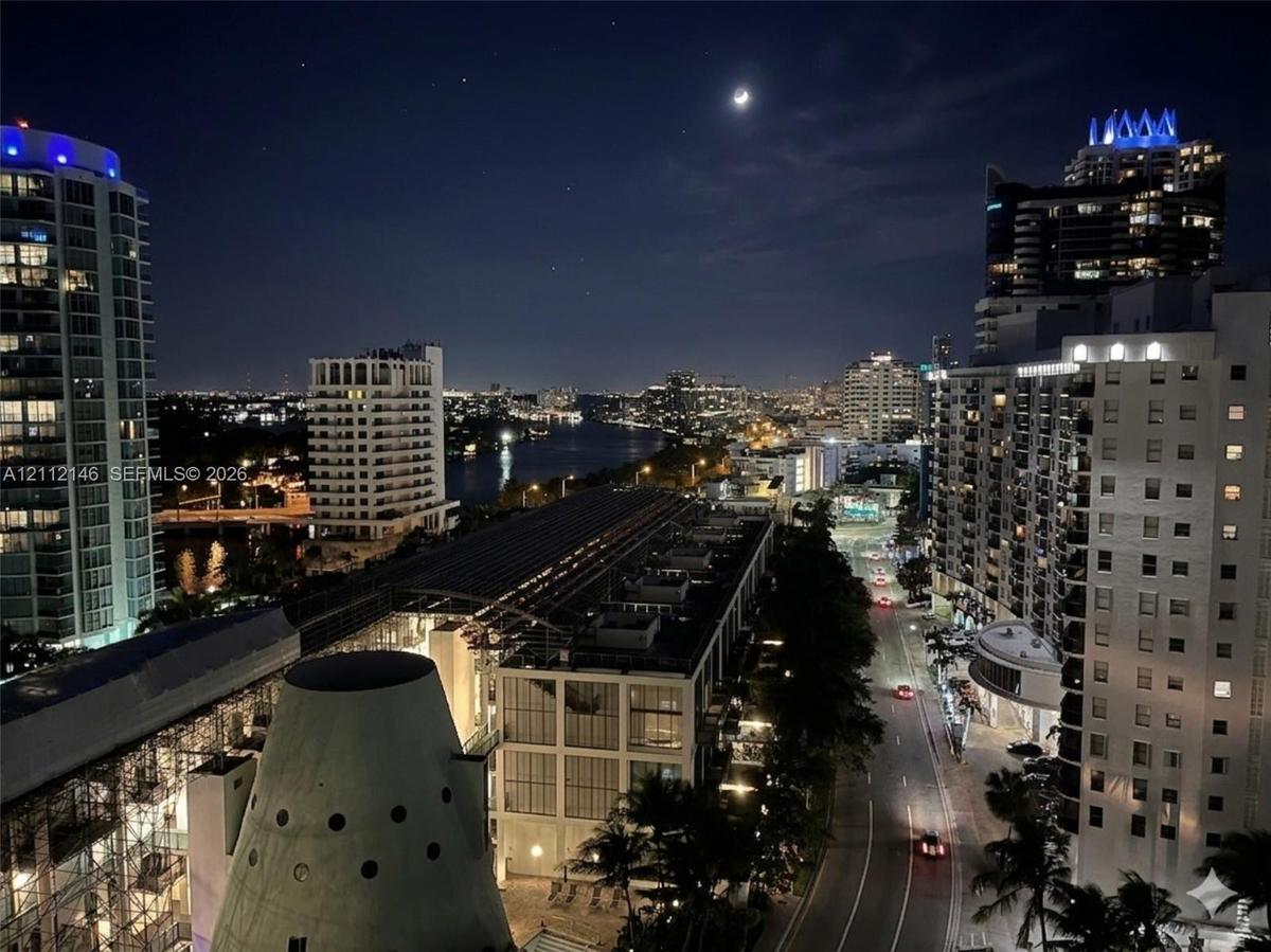 Panoramic city skyline featuring high-rise buildings, urban thoroughfare, and waterfront scenery