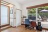 Tile flooring, wood-trimmed door frames, and a large sliding glass door