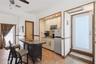 Kitchenette featuring light-finish cabinetry, stone-top counter island, ceramic tile flooring, built-in recessed lighting, and exterior doors
