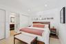 Terrazzo flooring, recessed ceiling lighting, horizontal clerestory window, and louvered-style closet doors