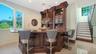 custom bar ideal for entertaining, stairs lead to second floor private owners suite