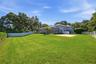 Large fenced backyard with mature landscaping