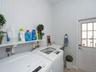 inside laundry room with door to side of house by outside shower