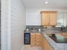 Wine frig in kitchen with pretty ship lap wall accent