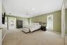 First Floor - Primary Suite offers two walk-in closets and access to Lanai