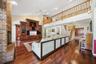 Great Room with wood flooring, built-ins and view to the Gallery / Loft area above