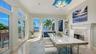 formal dining room with walls of windows to the water