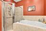 Primary Bedroom with En-Suite Bathroom, His & Her Walk-in Closets, Double sinks with Granite countertops, jacuzzi tub, separate shower