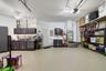 Another view of this magnificent garage space with custom workshop and storage shelves