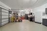 Immaculate garage with tech floor finish/S/S Cabinets, plenty of storage !!