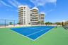 Private tennis courts provide an exceptional recreational amenity within this exclusive beachfront community.