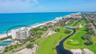 Spectacular aerial views showcase the turquoise Gulf waters, lush fairways, and exceptional coastal setting of the Longboat Key Club.