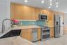 Maple cabinets, quartz counters and tile backsplash