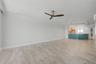 Step back in from the balcony to the Living area and looking into the kitchen.