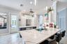 Kitchen opens to family room with fireplace